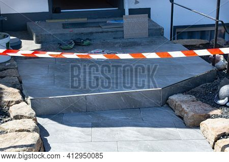 The Construction Worker Evenly Spreads The Surface Of The Stairs With Cement Adhesive Mass Using A S