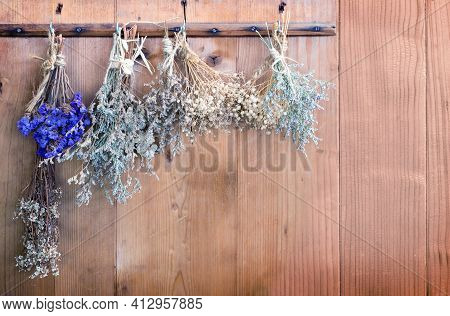 Hanking Dry Flower For Aromateraphy At Wood Door For Background