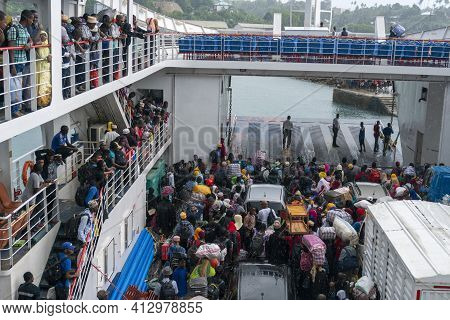 Zanzibar, Tanzania - 5 January 2020: Crowd Of Local Black Muslim African People Under Rain Are Waiti