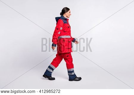 Full Length Body Size Profile Side View Of Nice Cheerful Girl Doc Rescuer Walking Isolated Over Grey