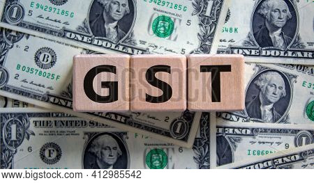 Gst, Goods And Services Tax Symbol. Concept Words Gst, Goods And Services Tax On Wooden Cubes On A B