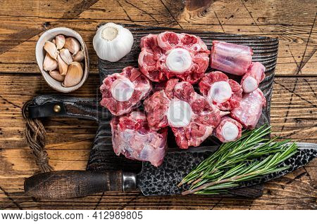 Raw Beef Oxtail Cut Meat On Wooden Cutting Board With Knife. Wooden Background. Top View