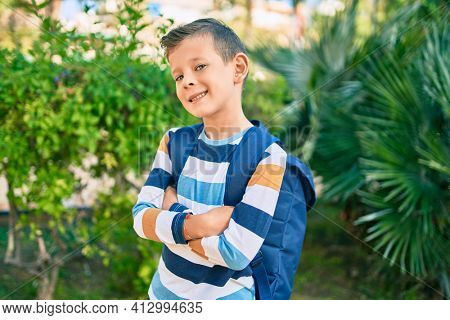 dorable caucasian student boy smiling happy standing at the park.