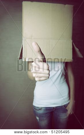 faceless girl with box on her head LIKE with thumb up, social network concept, toned