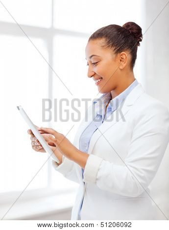 office, business, technology and internet concept - businesswoman with tablet pc in office