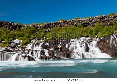 Hraunfossar is a very beautiful Icelandic waterfall in the west of the island. It comes from the lava field and pours into the Hvita river with a incredibly blue water. Long exposure.