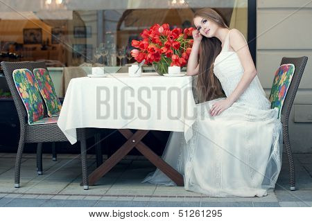 Portrait Of Young Pretty Woman Sitting In Restaurant