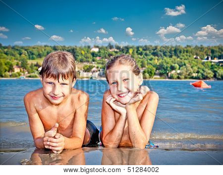 Boy and Girl on the public beach Strand at Danube river in Novi Sad, Serbia.