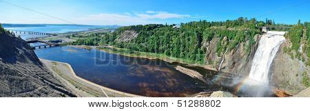 Montmorency Falls panorama with rainbow and blue sky near Quebec City.