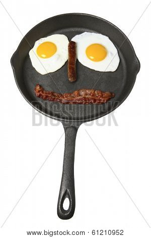 Breakfast in skillet in shape of a face on white background