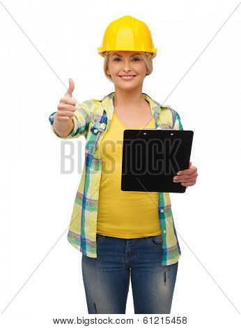 repair, construction and maintenance concept - smiling woman in helmet with clipboard showing thumbs up