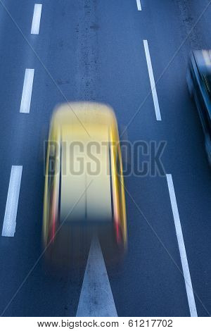 A blurred yellow car.