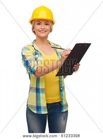 repair, construction and maintenance concept - smiling woman in helmet with clipboard