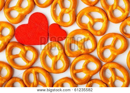 Valentine's Day Background Pretzels Pattern And Red Heart.
