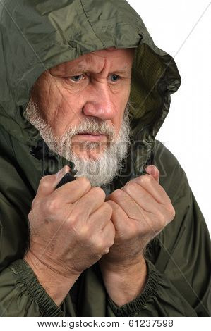 pathetic senior man in green waterproof jacket