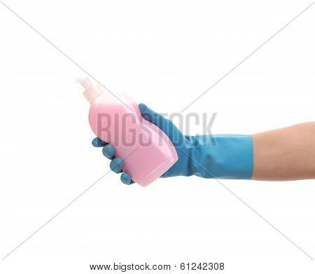 Hand in glove holding plastic bottle.