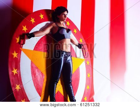 Young woman standing in circle for throwing knives.