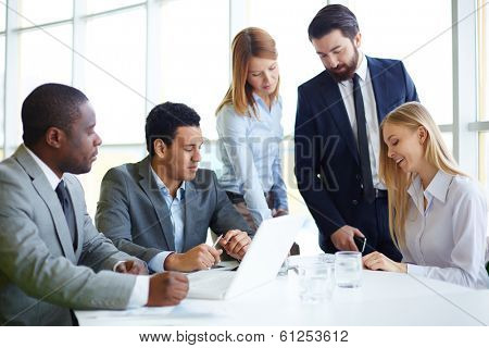Group of business partners discussing ideas and planning work in office