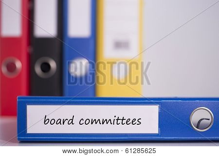 The word board committees on blue business binder