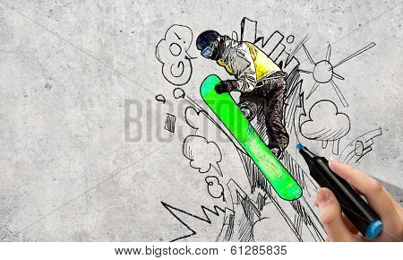 Close up of hand drawing sketches of snowboarder