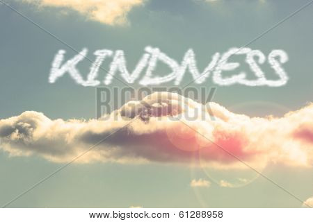 The word kindness against bright blue sky with cloud