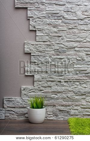 Room interior with stone wall, vinyl wallpaper and wood floor background.