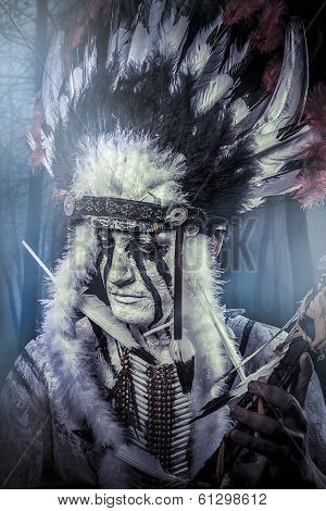 American Indian warrior, chief of the tribe. man with feather headdress and tomahawk