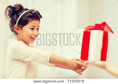 holidays, presents, christmas, birthday concept - happy child girl with gift box