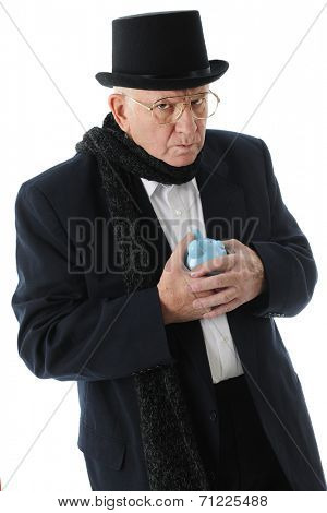 A miserly Scrooge glaring at the viewer while clutching his piggy bank.  On a white background.