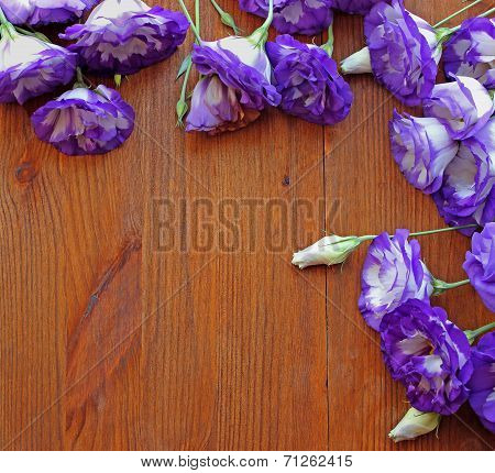 Bouquets Of Purple Eustoma Flowers On The Wooden Table