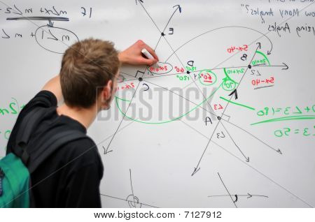 Student Writing Math On Whiteboard