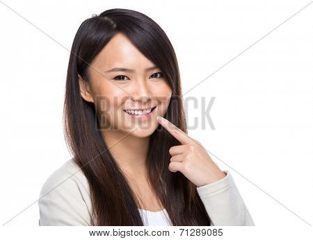 Woman with finger point to teeth