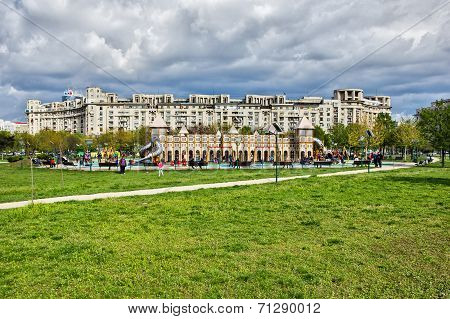 Children play-zone in Izvor park in Bucharest, against group of blocks and cloudy sky