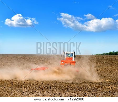 tractor in a field plowing
