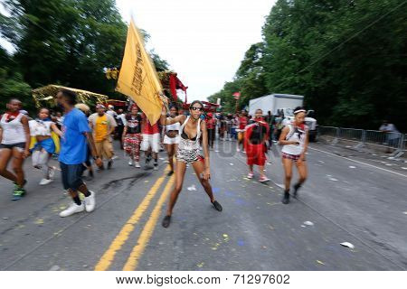 Revelers with flags advance on Flatbush