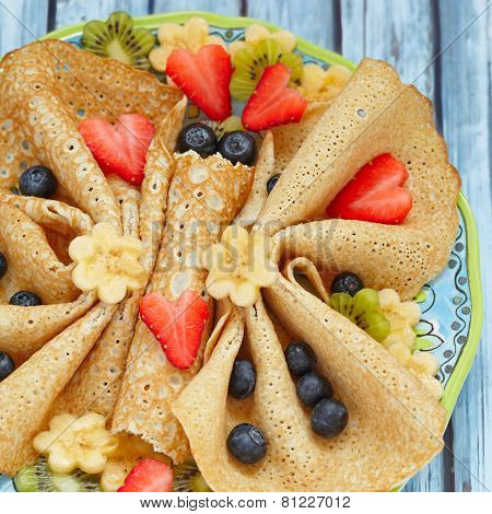 Funny butterfly shaped crepes with berries