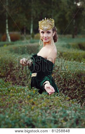 Elegant Young Woman Dressed Like Queen Walking In Garden