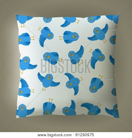 Pillow with blue bird pattern.