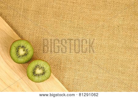 Cutted green kiwi on the wood board