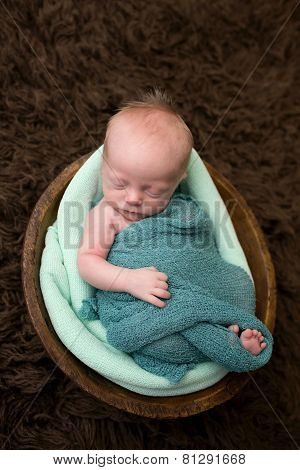 Sleeping Newborn In A Bowl