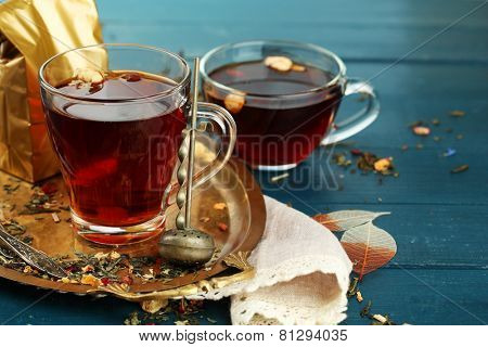 Beautiful vintage composition with herbal tea, on wooden table