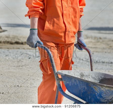 Worker Pushing Wheelbarrow