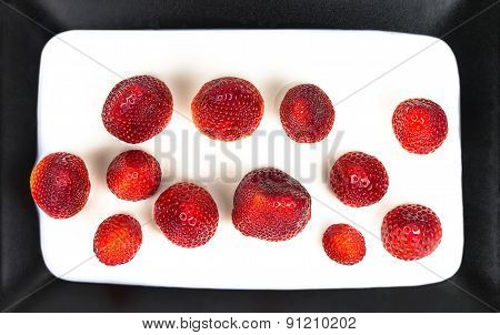 Strawberry in milk on a plate