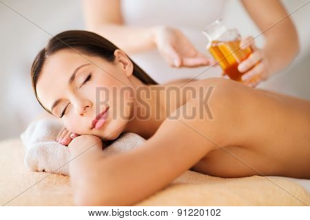 beauty, spa, resort and relaxation concept - beautiful woman in spa salon