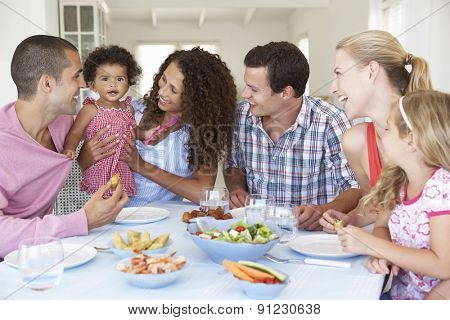 Families Enjoying Meal Together At Home