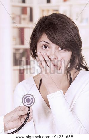 Beautiful young girl looking nervous at the doctor's appointment