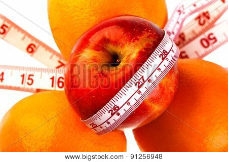 Three Oranges And Apple With Tailor's Ruler. Fruit Healhy Vitamin Diet Helps To Lose Weight.
