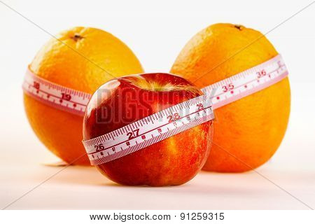 Oranges And Apple With Tailor's Ruler. Fruit Healhy Vitamin Diet Helps To Lose Weight.
