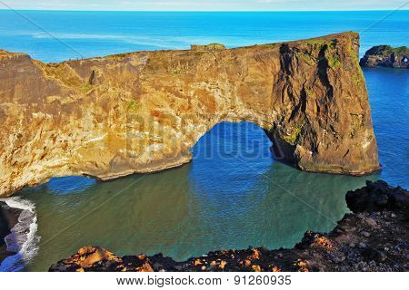 Cape Dyrholaey in southern Iceland. Sunset in July. The colossal rock in the sea in the form of an elephant