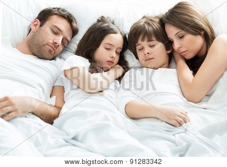 Family of four sleeping
